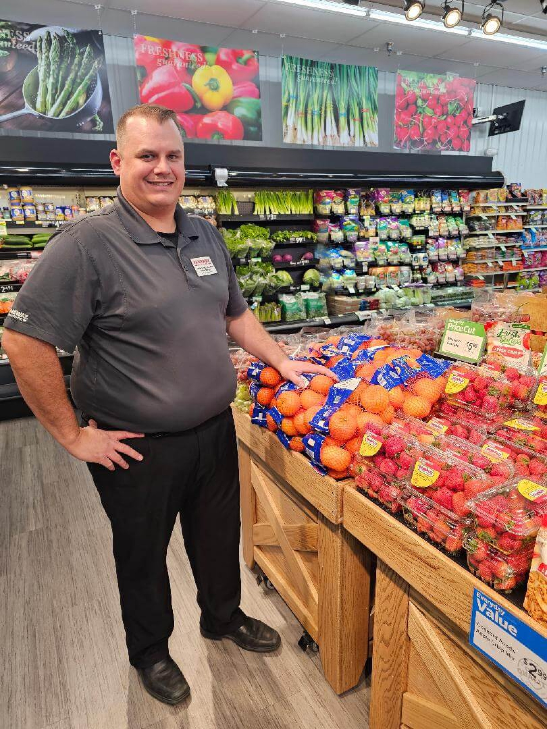 Farewell Rockwell City's Store Manager, Dave Kistenmacher, stands in front of the store's produce.
